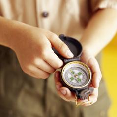 boy scout holding a compass
