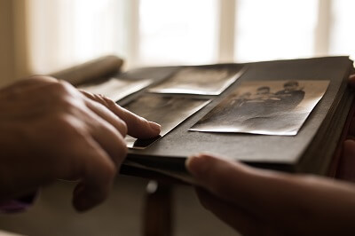 Closeup of finger pointing at old family photo album