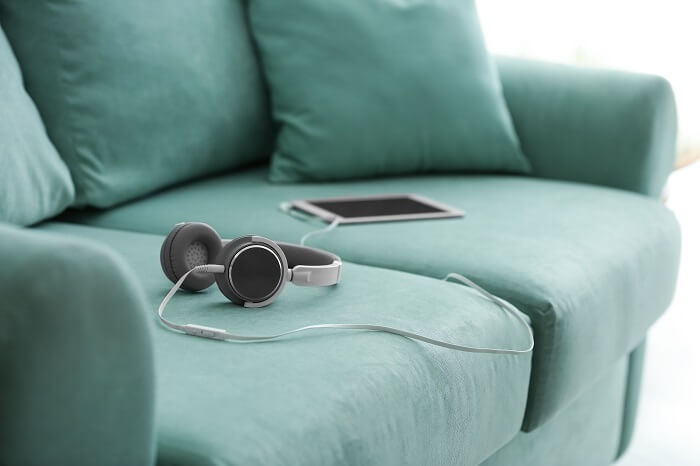 Tablet and headphones on a couch